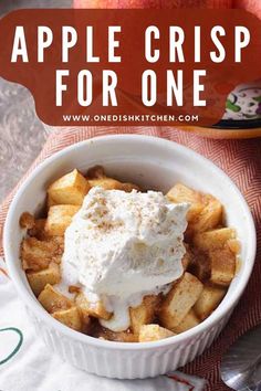 an apple crisp for one in a bowl with whipped cream and apples on the side