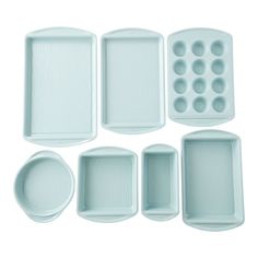 an assortment of trays and pans on a white background