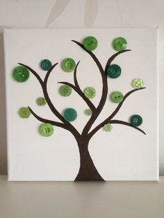 a white canvas with green buttons on it and a tree painted on the front side