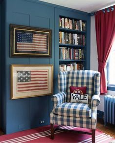 a chair in front of a bookshelf with an american flag pillow on it