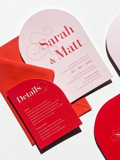 two red and white wedding stationery cards on top of each other with the same design