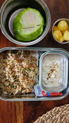 there is a metal container with rice and vegetables in it, along with other food items