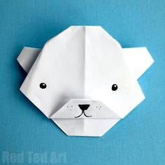 an origami polar bear head on a blue background