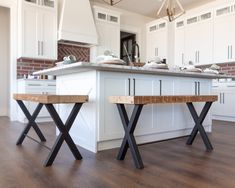 a kitchen island with two benches in front of it