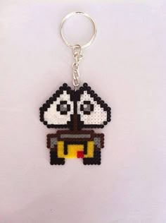 a pixel keychain with a black and white sheep on it's face