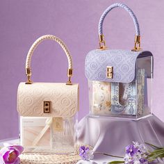 two purses sitting next to each other on a table