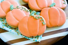 several decorated pumpkin cookies sitting on top of a plate