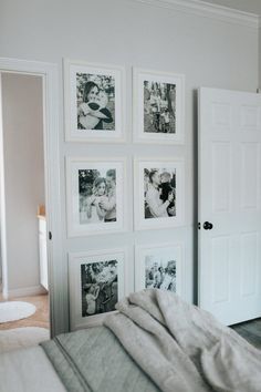 a bedroom with pictures on the wall and a bed in front of two white doors