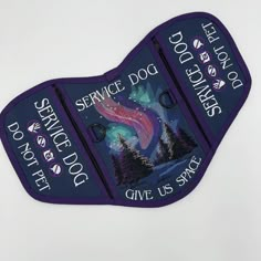 two purple dog tags that say service dogs, give us stars and the night sky