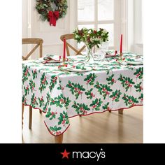 a christmas table cloth with holly leaves on it