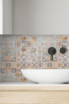 a bathroom sink sitting under a mirror next to a wall mounted faucet in front of a window