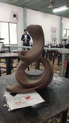 a sculpture sitting on top of a table in a room filled with tables and chairs