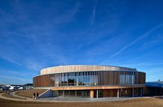 a circular building with wooden slats on the outside