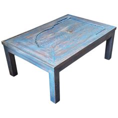 a blue coffee table sitting on top of a white floor