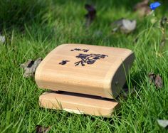 a small wooden box sitting in the grass