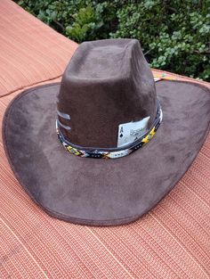 This stiff brim cowboy hats is stylish while keeping the sun out your eyes. These hats come in 3 colors (Brown, Cardinal and Black) and  3 style variants (Card only, Card and Paint, or Card, Paint and Beaded Band). Personalization can be  fulfilled including hat color, painting symbol or choosing playing card or cards (2 cards max). Adjustable Western Costume Hats For Outdoor, Southwestern Wide Brim Felt Hat For Western-themed Events, Western Style Adjustable Costume Hats For Outdoor, Western Adjustable Costume Hats And Headpieces For Outdoors, Adjustable Brown Country Costume Hat, Brown Adjustable Country Costume Hats, Southwestern Brimmed Felt Hat For Rodeo, Southwestern Wide Brim Felt Hat For Rodeo, Southwestern Style Wide Brim Felt Hat For Rodeo