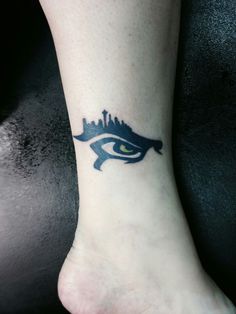 an eye tattoo on the ankle