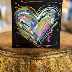 a heart painted on top of a black box