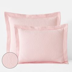 two pink pillows and one light pink pillow