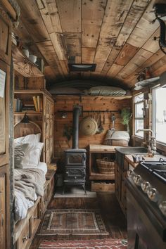 the interior of a tiny cabin with wood paneling and a stove top oven in it