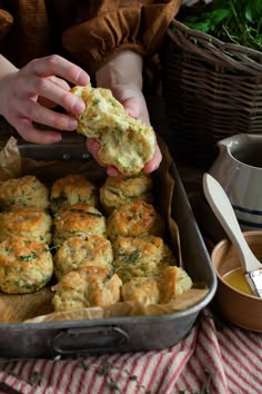 a person is taking some food out of a baking pan and holding it in their hand