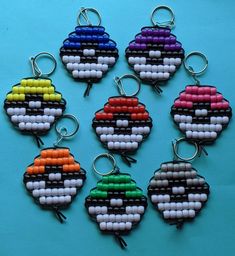 six keychains made out of beads with different colors and shapes on each one