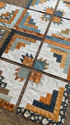 the quilts are laid out on the floor to be used as wall hangings