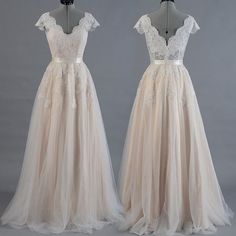 two dresses on mannequins, one in white and the other in beige