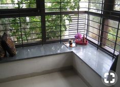 a window sill with two vases sitting on top of it