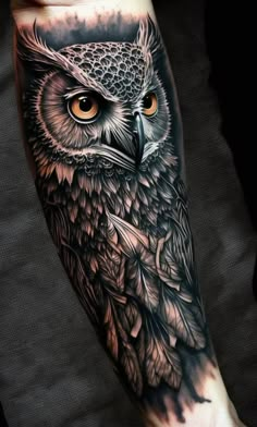 an owl tattoo on the arm with orange eyes and leaves around its head, is shown