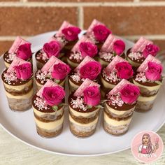 there are many desserts on the plate with pink frosting and rose decorations in them