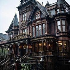 an old victorian style house with many windows and balconies