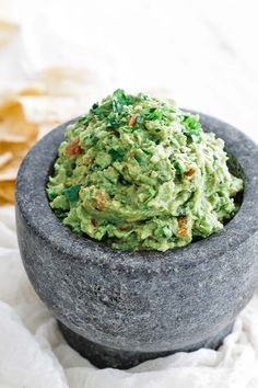 a bowl filled with guacamole and chips