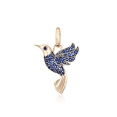 a blue and white bird charm on a gold plated chain, with crystals in the wings