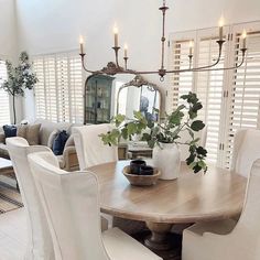 a dining room table with white chairs around it