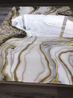 a glass table with gold and white designs on it