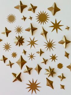 gold stars are arranged on a white surface