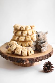 a small teddy bear sitting next to some cookies