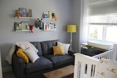 a baby's room is decorated in gray and yellow with pictures on the wall