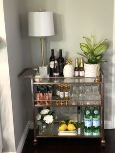 a bar cart filled with bottles and glasses