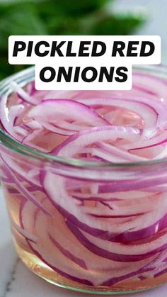 a glass bowl filled with sliced red onions