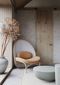 a chair and table in a room with wood paneling on the wall behind it