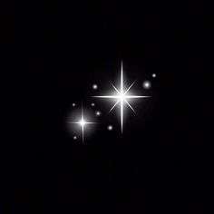 three bright stars shine in the dark sky