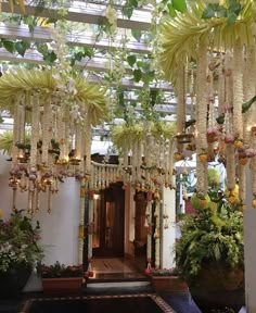 the entrance to a building decorated with hanging flowers