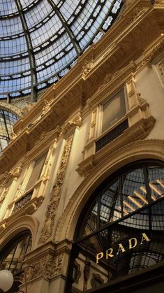 the inside of a building with glass ceiling and ornate architecture on it's sides