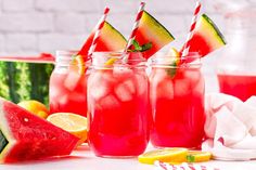 three mason jars filled with watermelon, lemon and limeade drink garnished with striped straws