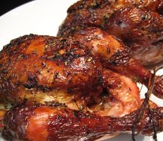 two pieces of cooked chicken on a white plate