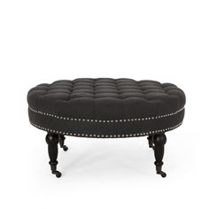 a black ottoman sitting on top of a white floor