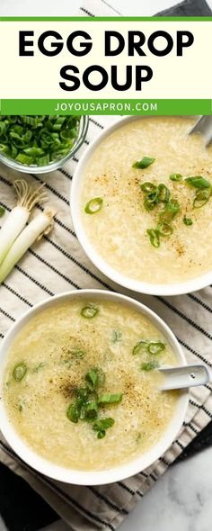 two bowls of egg drop soup on a striped place mat with green onions and celery