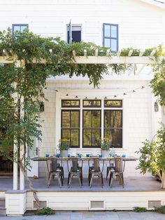 an outdoor dining table and chairs on a patio